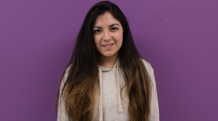 Student standing in front of a wall